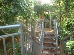 a staircase leading up to a tree at Tourist Nest Hotel in Kampala