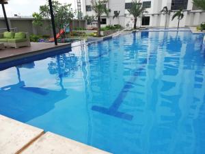 a swimming pool at a hotel with blue water at Nica's Place Property Management Services at Horizons 101 Condominium in Cebu City