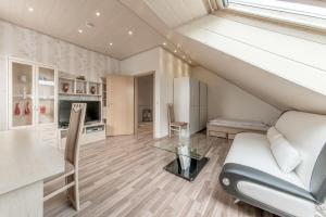 a living room with a white couch and a table at Apartments or Rooms near Exhibition Center in Hannover