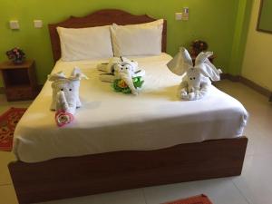 three stuffed animals are sitting on a bed at Sun & Earth Villa in Mont Choisy