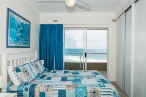 a bedroom with a bed with a view of the ocean at The Boulders 503 in Ballito