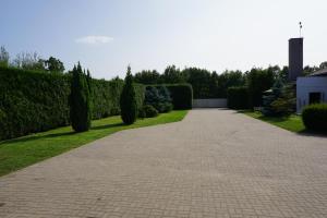 a walkway in a garden with bushes and trees at Kwatery pracownicze in Łódź