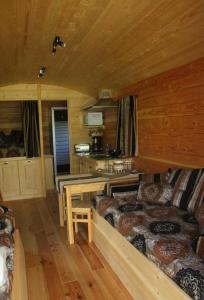 a room with two beds in a log cabin at les roulottes de dilou Cerise in Matha