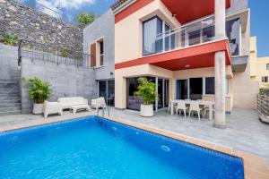 a villa with a swimming pool and a house at SuperMakar10 - Green Palm in Santa Úrsula