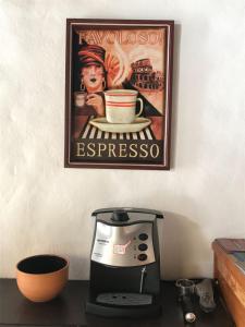 a poster of a man holding a cup of espresso at Aquarius Osteria in Arraial do Cabo +28 photos
