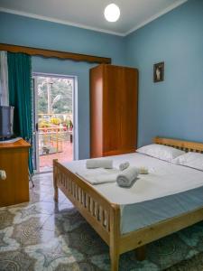 a bedroom with a large bed with towels on it at Guesthouse Belle View in Berat