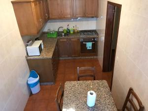 a small kitchen with a table and a counter top at Douro vineyards and Mountains in Urgueira