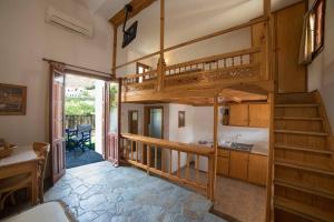 a living room with a loft bed and a kitchen at Nicolas Pension in Skiros