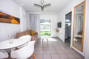 a living room with a white table and chairs at Servatur Terrazamar Sun Suite in Puerto Rico de Gran Canaria