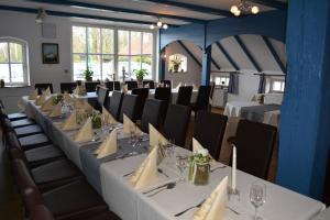 a set of tables in a room with chairs and tablesktop at Hotel Garni Kastanjehoff in Timmel