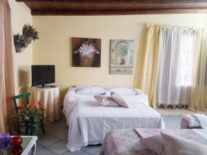 a bedroom with two beds and a tv in it at Mamma Sicilia in Mazara del Vallo