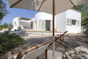 a view of the house from under an umbrella at La Macchia in Leuca