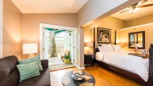 a bedroom with a bed and a living room at L'Habitation Guesthouse- Adult Exclusive in Key West