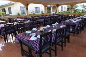 una fila de mesas y sillas en un restaurante en Springlands Hotel en Moshi