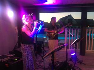 a man and a woman playing instruments on a stage at Camping Kost Ar Moor in Fouesnant +55 photos