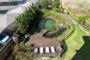 una vista aérea de un jardín con una pasarela de madera en Hotel Verde Cape Town Airport, en Matroosfontein