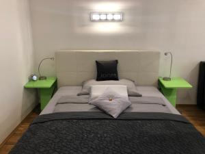 ウィーンにあるDesign Apartment - Centrally locatedのベッドルーム1室(ベッド1台、緑のテーブル2台付)
