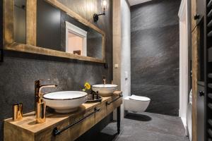 a bathroom with two sinks and a mirror at Wooden Horse - New Apartment - Old Town in Kraków