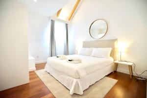 a hotel room with a bed and a lamp at São Paulo 190 - Luxury Apartments in Lisbon