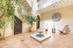 a room with a courtyard with trees and a statue at Riad Privé De Luxe Au Coeur De La Kasbah Avec Hammam in Marrakesh