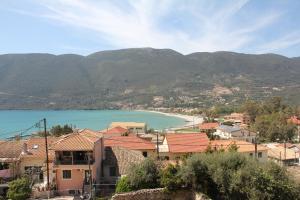 a view of a town with a beach and mountains at Liotrivi Studios in Vasiliki