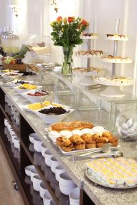 a buffet line with various pastries and desserts on it at MR Express (ex Hotel Neruda Express) in Santiago