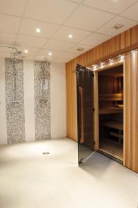 an empty room with a door in a room at Best Western Plus Hostellerie Du Vallon in Trouville-sur-Mer