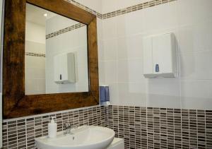 a bathroom with a sink and a mirror at Cristal Rooms in Piacenza +18 photos