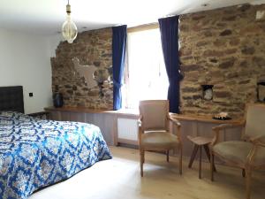 Postel nebo postele na pokoji v ubytování Le vieux moulin