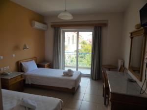 Voodi või voodid majutusasutuse Hotel Lykeon toas