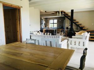 Un comedor con una mesa de madera y sillas blancas. en Pringle @ 865 Jally, en Pringle Bay 22 fotos más