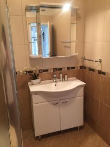 a bathroom with a white sink and a mirror at Apartment Dubcic: For perfect vacation in Dubrovnik