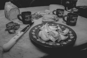 a plate of food on a table with cups and a knife at Adega Do Martinho in Milhão +7 photos