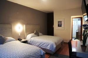 Giường trong phòng chung tại Casa Massima Hotel