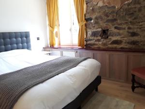 Postel nebo postele na pokoji v ubytování Le vieux moulin