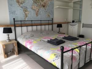 ein Schlafzimmer mit einem Bett mit zwei schwarzen Handtüchern darauf in der Unterkunft Beach House SEA-side in Egmond aan Zee