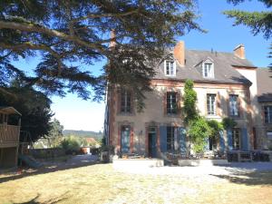 an old house with a tree in front of it at maison courbarien in Saint-Georges-la-Pouge