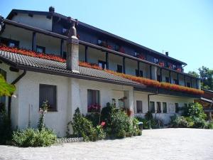 a building with flowers on the top of it at Albergo Negritella in Borgo