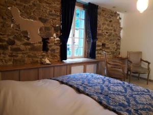 Postel nebo postele na pokoji v ubytování Le vieux moulin