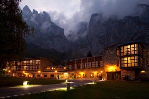 a building in front of a mountain at night at Parador de Fuente Dé in Fuente Dé