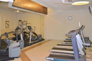 a gym with treadmills and machines in a room at Sunchase Inn & Suites in South Padre Island
