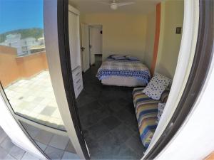 Ένα ή περισσότερα κρεβάτια σε δωμάτιο στο Praia Linda Hospedagem
