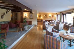 a restaurant with chairs and tables in a room at Parador de Fuente Dé in Fuente Dé