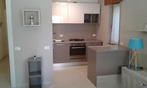 a kitchen with a sink and a stove top oven at Shabby house Donatella in Carenno