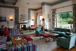 a living room with couches and chairs and a fireplace at Parador de Fuente Dé in Fuente Dé