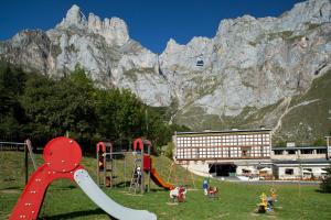 a playground with a slide in front of a mountain at Parador de Fuente Dé in Fuente Dé
