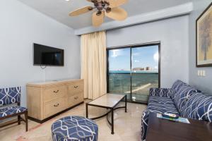 a living room with a couch and a large window at Peñasco del Sol Hotel in Puerto Peñasco