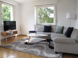 a living room with a couch and a table at Hygge Apartments Bonn in Bonn