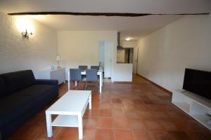 a living room with a couch and a table at Les Arches - Pardigon in La Croix-Valmer
