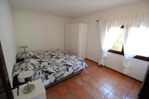 a bedroom with a bed and a window at Les Arches - Pardigon in La Croix-Valmer +24 photos